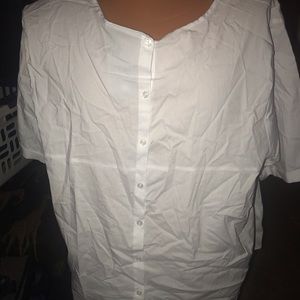 Tag still on white top. Buttons are worn in back.
